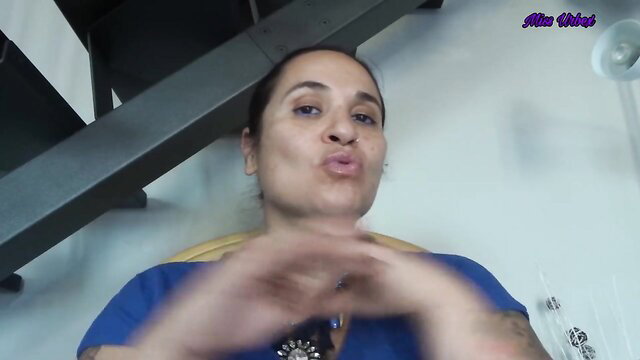 Mixed-race mature woman in scrubs puckers lips, signs about sissification