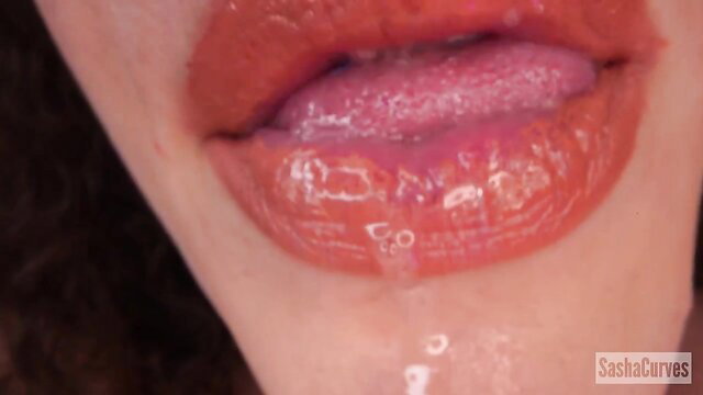 Sasha Curves glossy red lips dripping saliva closeup