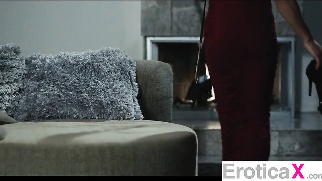 Kira Noir in tight red dress by fireplace, high heels, sexy pose