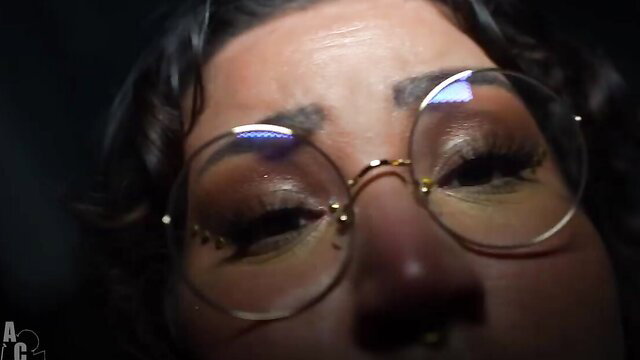 Closeup of curvy BBW's seductive eyes and glasses in dim light