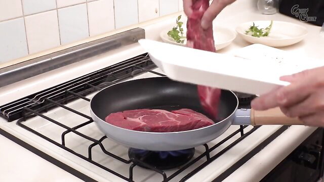 Cooking raw steak in pan, closeup meat handling
