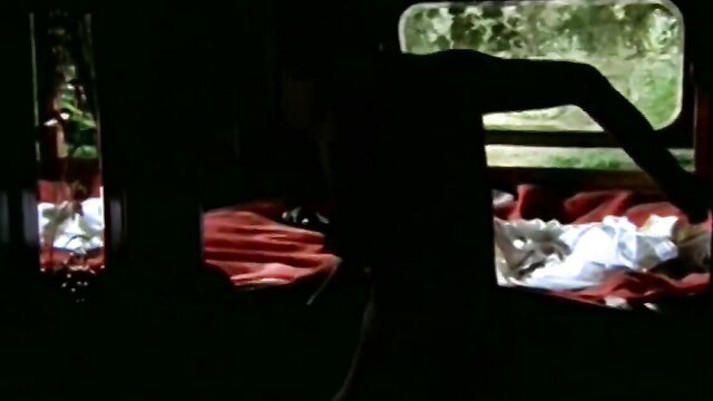Vintage train sex scene with woman in red sheets and shadowy lover