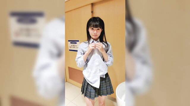 Japanese schoolgirl in plaid skirt unbuttoning white blouse, teasing upskirt