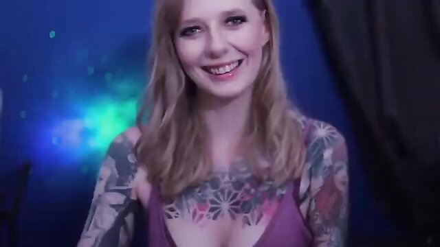 Smiling blonde tattooed girl in purple tank top ASMR thumbnail