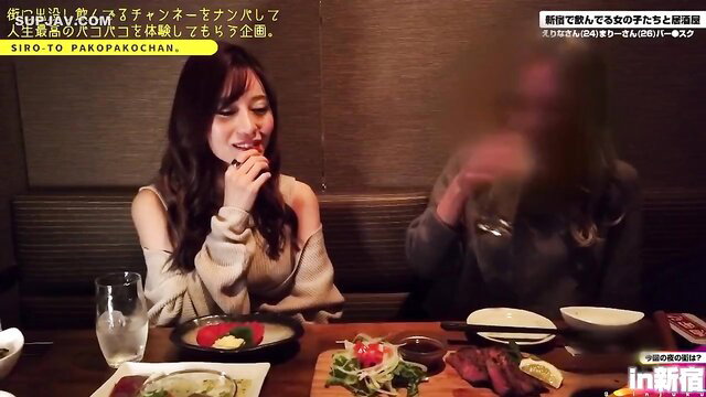 Two smiling Japanese women in off-shoulder tops at dinner table on JAV show