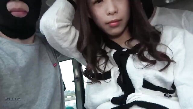 Asian girl in white Chanel jacket with masked man in car on JAV bus tour