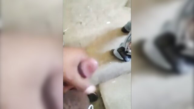 Blurry hand stroking cock in restroom cruising glory hole scene