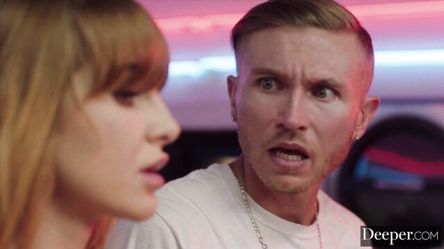 Maitland Ward intense eye contact in neon-lit threesome scene