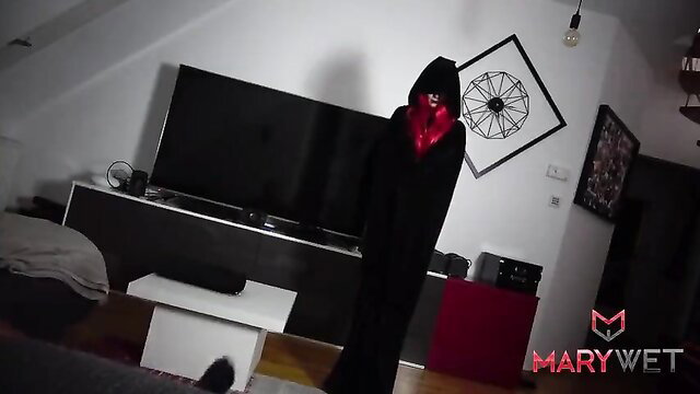 Mary Wet in sexy black hooded Halloween costume with red scarf