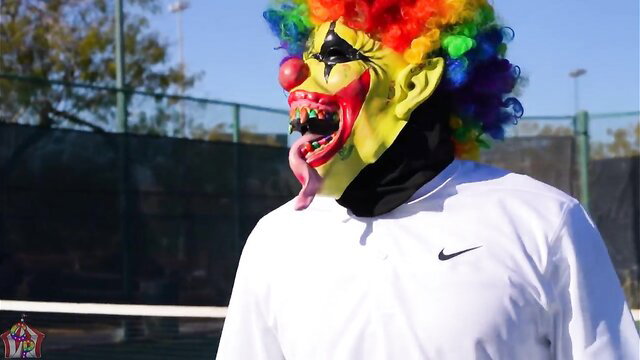 Cali Caliente in creepy clown mask teases tongue out at tennis court