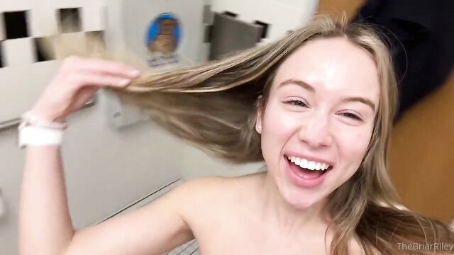 Briar Riley nude smiling, flipping long blonde hair in bathroom
