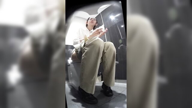 Japanese woman sitting on toilet in pants, spied in station bathroom
