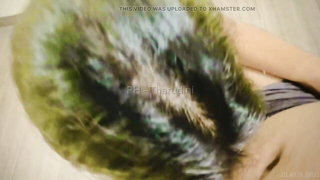 Blurred Indian hooker with green hair lying topless on bed