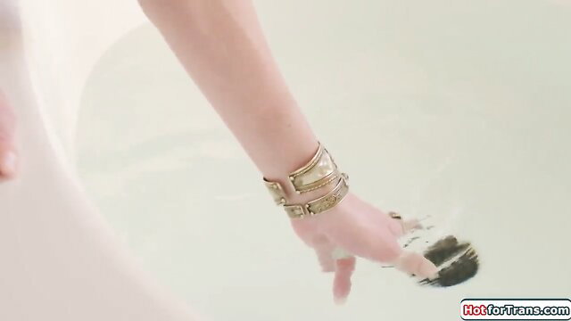 Ariel Demure's elegant hand with gold bangle in bath, sexy tease
