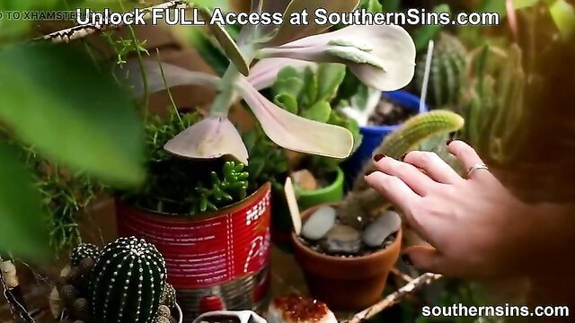 Chloe B hand near plants in Southern Sins lesbian tease
