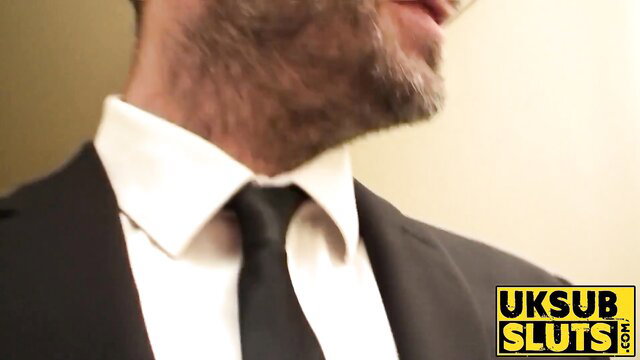 Handsome suited dominant man in suit and tie closeup