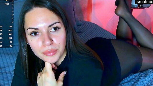 Lolla Spencer seductive pose in black sheer stockings and dress on bed