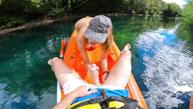 Blonde babe in bikini gives risky outdoor handjob on kayak