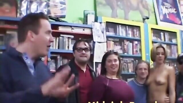 Riley Brooks topless in video store with crowd, tall blonde allure