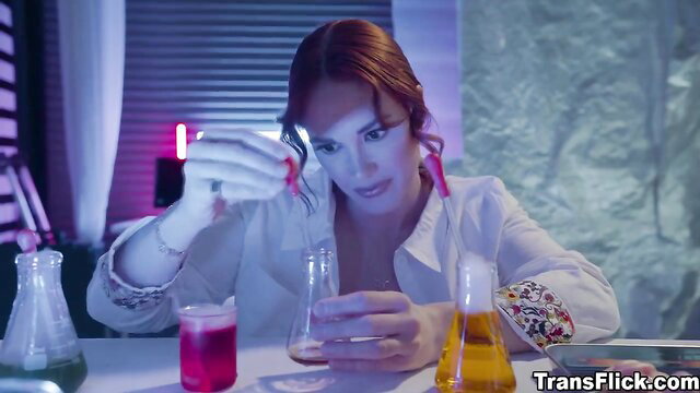 Redhead scientist in lab coat mixing colorful potions in lab