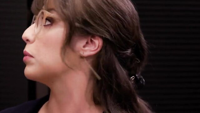 Ariel Demure profile view, sultry office look with glasses and loose hair