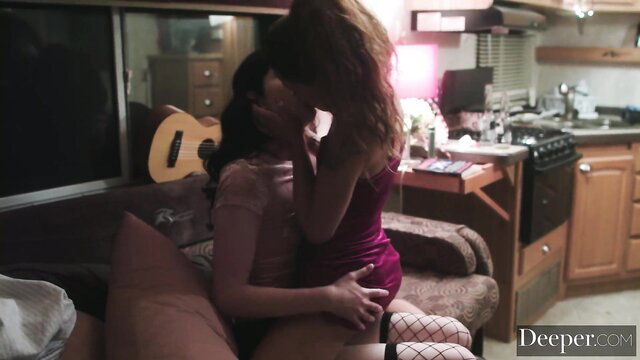 Holly Hendrix and Evelyn Claire passionately kissing on couch