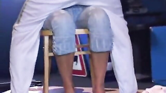 Asian woman seated bare legs spread in white top blue jeans upskirt tease