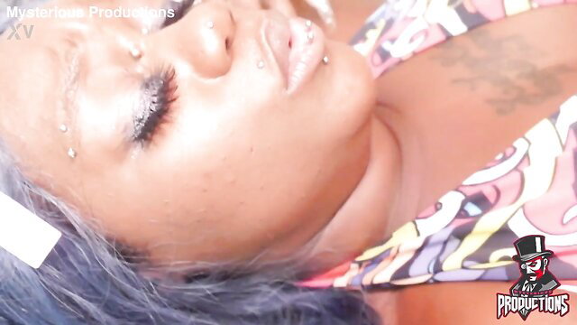 Closeup of black juicy mommy's face, heavy makeup, glossy lips, lying back horny