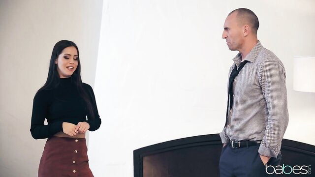 Alina Lopez in black turtleneck and burgundy skirt teases man