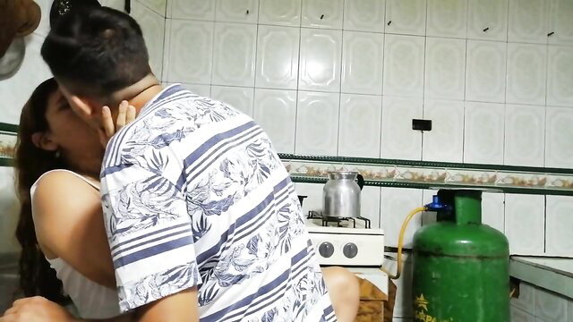 Latina couple passionately kissing in kitchen, amateur hookup
