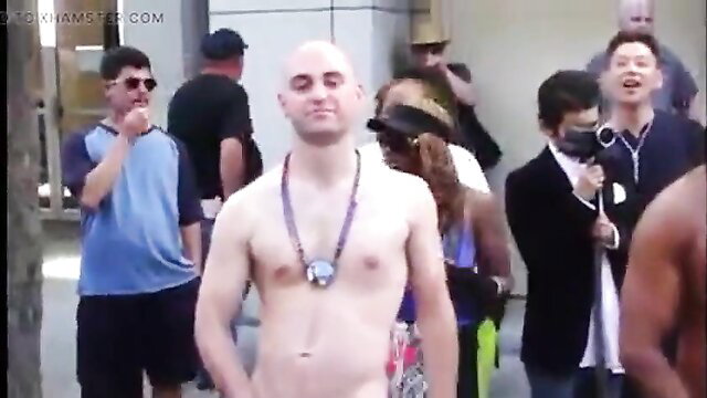 Bald hunk nude in public, flashing cock outdoors with crowd