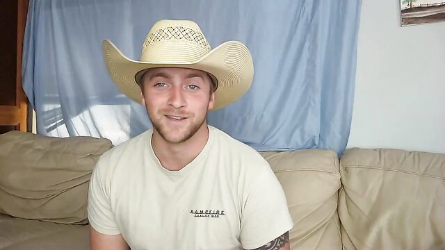 Cowboy guy in white tee smiles on couch, gay amateur teaser