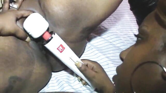 Ebony MILF using Hitachi wand vibrator on pussy closeup