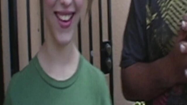 Smiling white teen in green tee with black man hand on her, amateur homemade sex thumbnail