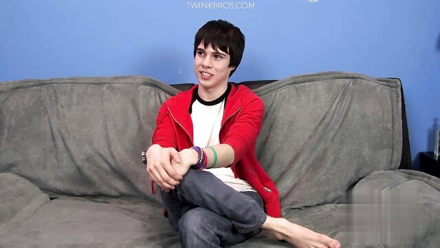 Kyler Moss twink in red hoodie on couch interview