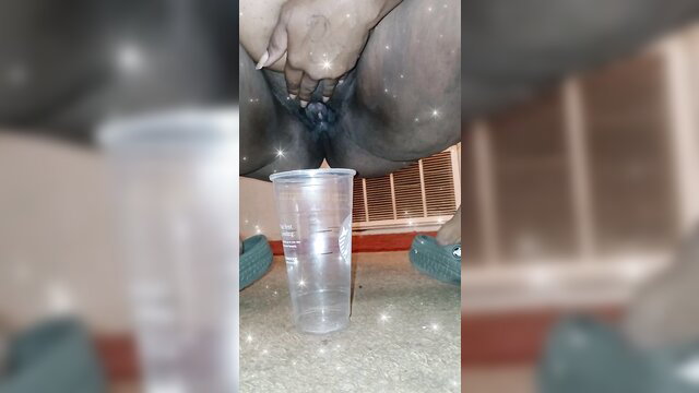 Thick ebony woman squatting over cup in thirsty cum fetish tease