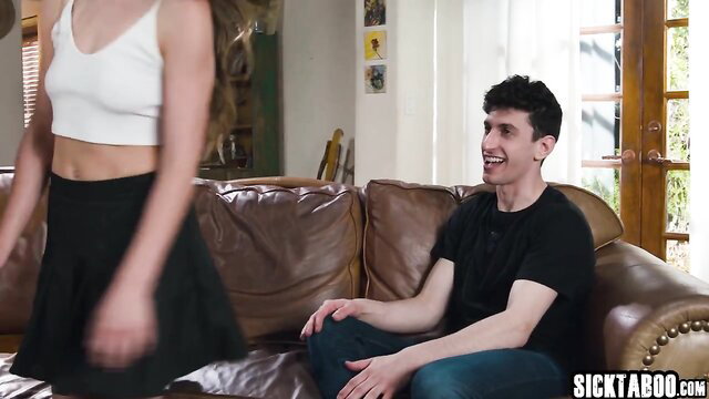 Girlfriend in white crop top and skirt teases boyfriend on couch