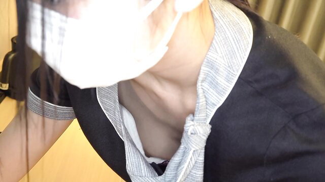 Asian woman in open blouse exposing cleavage, white mask, JAV tease
