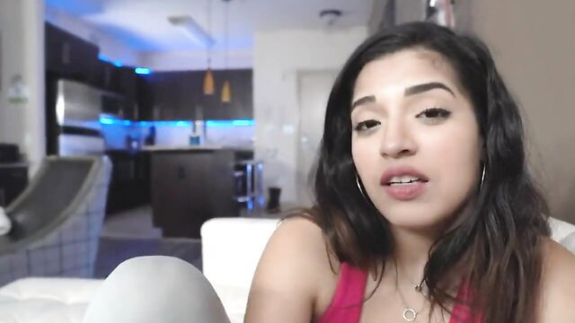 Curvy Arab teen in tank top smiles seductively closeup