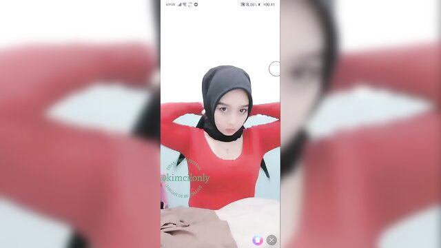 Kiki Palembang Indonesia in red tight top and hijab selfie