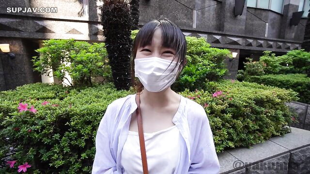 Cute Japanese girl in white cardigan and mask smiles outdoor JAV thumbnail