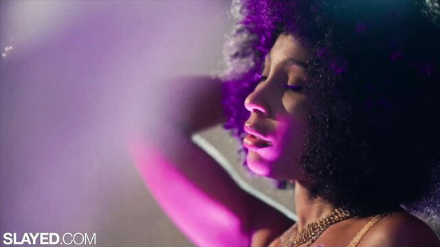 Vanna Bardot curly haired beauty in purple lit club tease