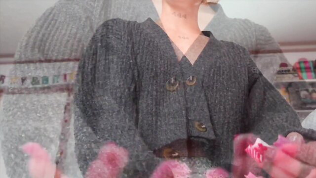 Elle Marz in gray cardigan flashing pink dildo closeup