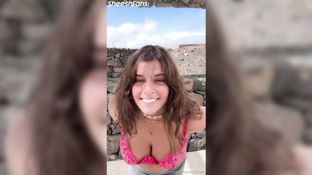 Millachats smiles in pink bra, flashing big tits outdoors