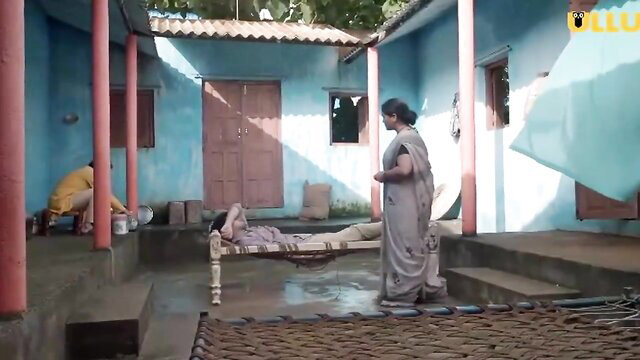 Indian MILF in saree stands by bed in hot Ullu series scene