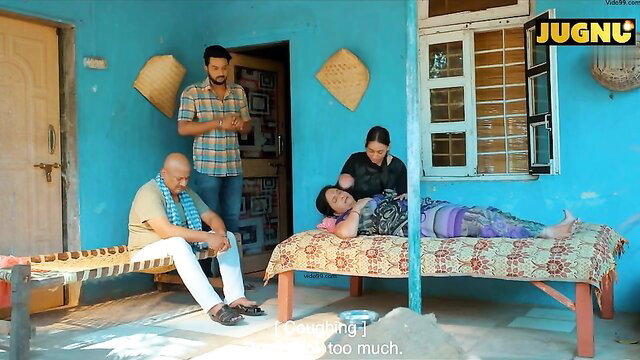 Indian MILF lying on cot with family in erotic desi softcore scene