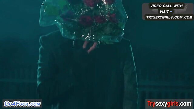 Mystery man offers roses in dark suit on erotic video call