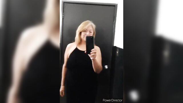 Blonde MILF in black dress selfie in public toilet mirror
