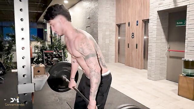 Tattooed gym trainer Danner Mendez deadlifting shirtless