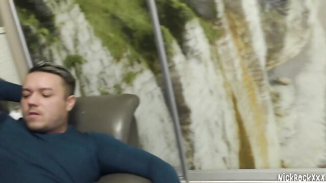 Nickrack XXX guy relaxes in chair with waterfall view